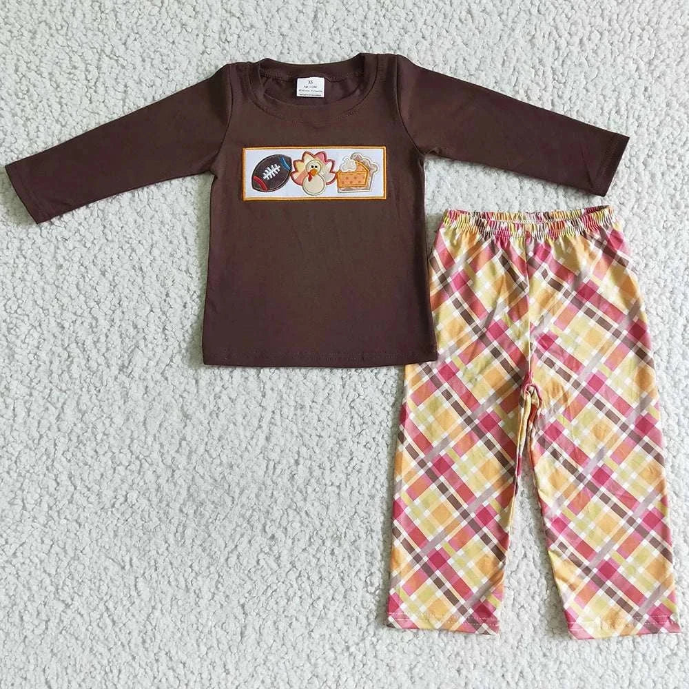 Toddler girls fall outfit with brown long-sleeve top featuring Thanksgiving turkey print and plaid pants