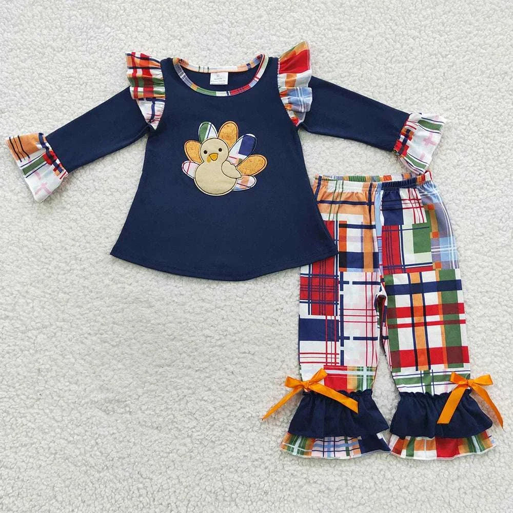 Toddler girls fall outfit with navy turkey print top and colorful plaid pants with ruffle details